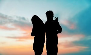 Silhouettes of partners face back to back while appearing to argue. Learn how a therapist in Huntsville, AL can support you in addressing relationship issues by searching for counseling Huntsville today.