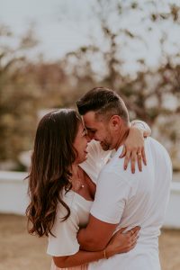 A man and woman hug each other and smile. Learn how online marriage counseling in Alabama can support your bond by searching for “marriage counselors huntsville al” or contacting a therapist in Huntsville, AL today.